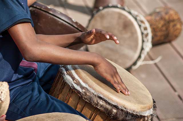 Drummer surrounded by African drums